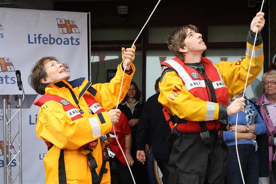 Photo: Celia Imrie and volunteer crew Max Rimmington raise the appeal flag