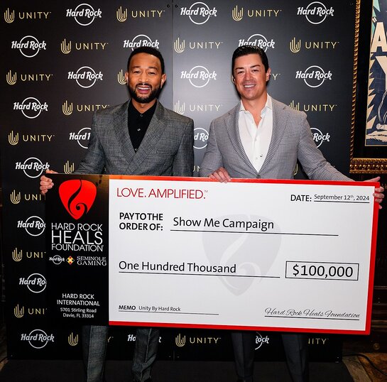 Keith Sheldon presents The Show Me Campaign check to John Legend on behalf of Hard Rock Heals Foundation